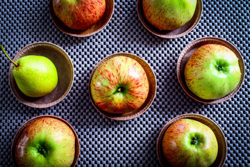 Apples on a brown table on a gray napkin, top view