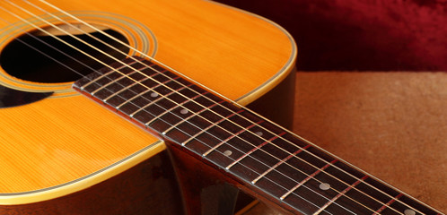 Musical instrument - Closeup fragment pickguard, strings and neck acoustic guitar