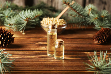 Pine nuts and bottles of Cedar pine nuts essential oil.