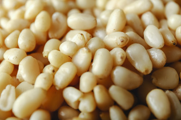 Background texture of shelled pine nuts. Cedar.