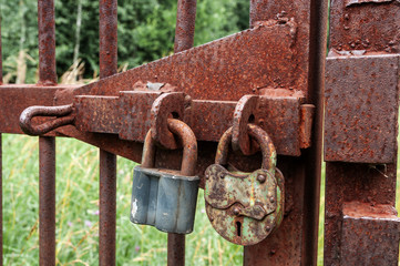 Two old lock on the gate to the park