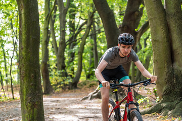Young man biking in forest