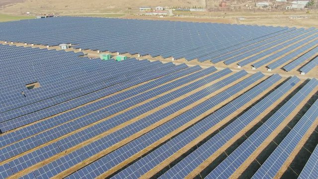 Aerial view, flight above solar panel photo voltaic power station.