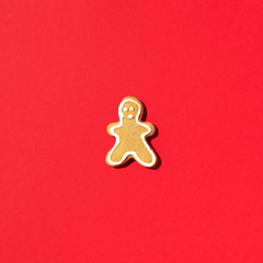 Gingerbread men on red background. Top view. Minimal creative card. Christmas and new year concept
