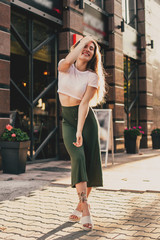 Smiling woman walk in the city on summer day.