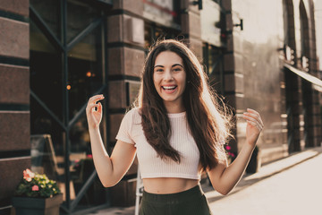 Smiling woman posing for the camera in the city on summer day.