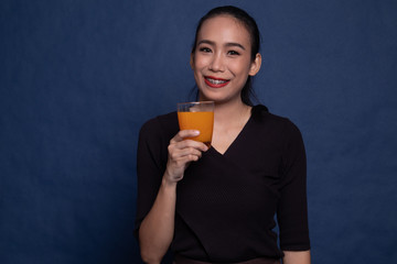 Young Asian woman drink orange juice.