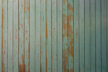 Fototapeta na wymiar Wall texture of wooden boards with peeling green paint