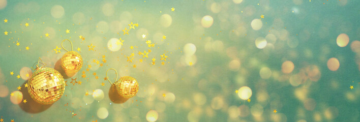 Creative Christmas concept. Shiny gold disco balls over green background. Flat lay, top view. New...