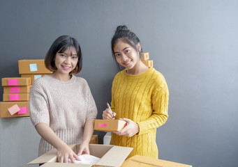 startup small business owner working with packing product workplace.happy woman seller check product order, packing goods for delivery to customer. Online selling, e-commerce, shipping concept