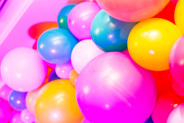 Fototapeta na wymiar Multicolored balloons. Blue, yellow, pink baloons, close up