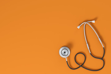 Stethoscope on orange background