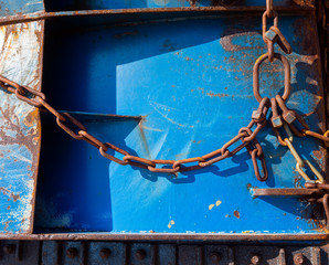 abstract blue part of rusty sheep hull and metal chain