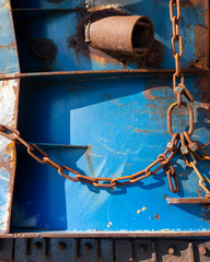 abstract blue part of rusty sheep hull and metal chain