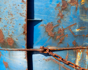 abstract blue part of rusty sheep hull and metal chain