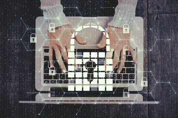 Hands using laptop with padlock