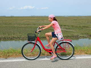 Cute little girl with bandana on the bike
