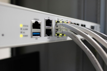 Network switch and ethernet cable connect to computer.