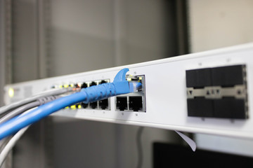 Network switch and ethernet cable connect to computer.