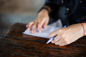 Fototapeta na wymiar Closeup of woman's left hand writing order