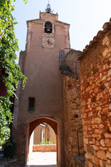 Fototapeta na wymiar narrow street in French village of Roussillon buildings colorful ochre in France