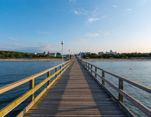 Footbridge on the beach with village