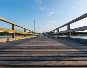 Obraz premium Footbridge on the beach with village