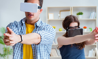 Young family playing games with virtual reality glasses