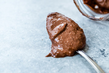 Homemade Organic Raw Nut Chocolate Cream in Spoon.