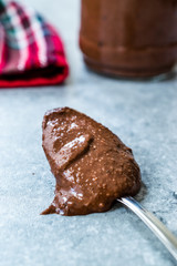 Homemade Organic Raw Nut Chocolate Cream in Spoon.