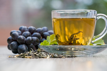 cup of tea with pear and grapes