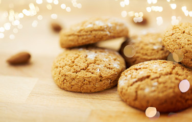 food, baking and eating concept - close up of homemade oatmeal cookies on wooden table