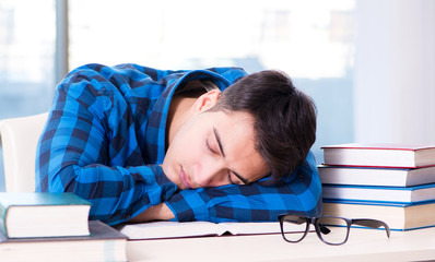 Student studying in the empty library with book preparing for ex