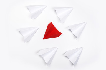 Group of white paper plane in one direction and one red paper plane pointing in different way on white background. Business for innovative