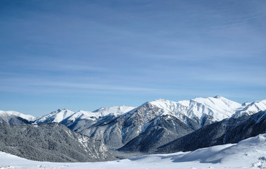 Snow-capped mountain peaks of the Caucasus mountain range near the resort of Arkhyz. Mountain peaks covered with snow in winter. Winter landscape.