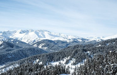 Snow-capped mountain peaks of the Caucasus mountain range near the resort of Arkhyz. Mountain peaks covered with snow in winter. Winter landscape.