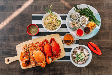 Top view of Steamed Giant Mud Crabs, Steamed Flower Crabs and Grilled Shrimps (Prawns) in wooden...