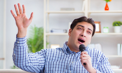 Funny man singing songs in karaoke at home