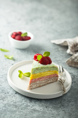 Homemade rainbow pancake cake with fresh raspberry