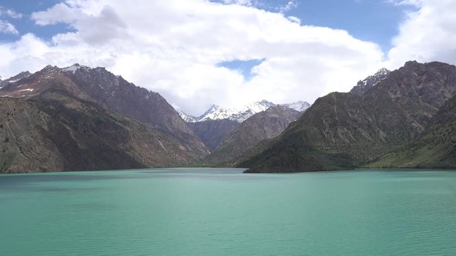 Sughd Iskanderkul Lake Breathtaking Picturesque View with Snow Capped Mountains at Background on a Sunny Blue Sky Day