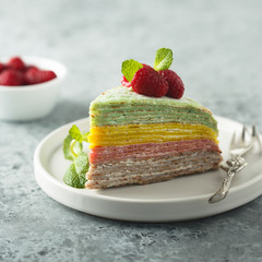 Homemade rainbow pancake cake with fresh raspberry