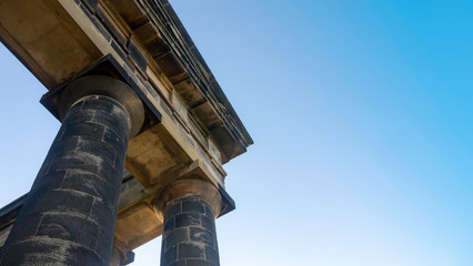 Penshaw Monument, Houghton le Spring in Sunderland - Corner close up of the monuments columns and stone work. Built in 1844 the Earl of Durham monument resembles the Temple of Hephaestus in Athens. - obrazy, fototapety, plakaty