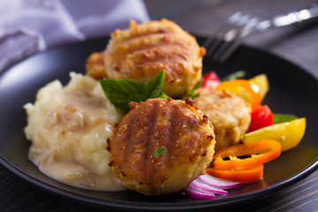 Fish cakes with mashed potatoes and vegetables. Fish patties. Fried cutlets of minced fish