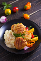 Fish cakes with mashed potatoes and vegetables. Fish patties. Fried cutlets of minced fish
