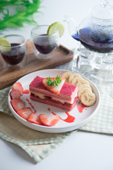 layered strawberry cake with slice of banana and strawberry