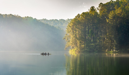 traveler rest on a wooden raft float in the reservoir, Beautiful nature and pine forest in the morning at Pang Ung(Pang Tong Reservoir) in Mae Hong Son Province, North of thailand