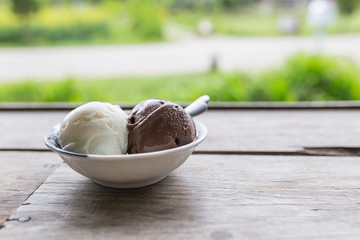 Fototapeta premium Bowl of various colorful ice cream balls on wooden background.