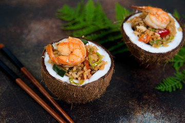 Traditional Asian food. Stir fry with rice, seafood and vegetables in coconut