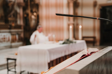 unrecognizable Priest during a wedding ceremony nuptial mass. Religion concept. Selective focus