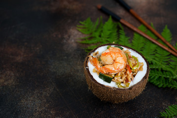 Traditional Asian food. Stir fry with rice, seafood and vegetables in coconut